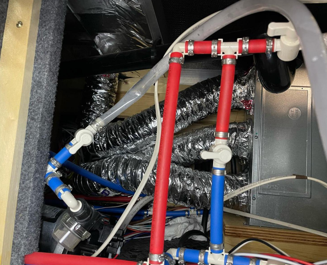 Burst PEX water line inside an RV being repaired by a mobile technician in Port St. Lucie