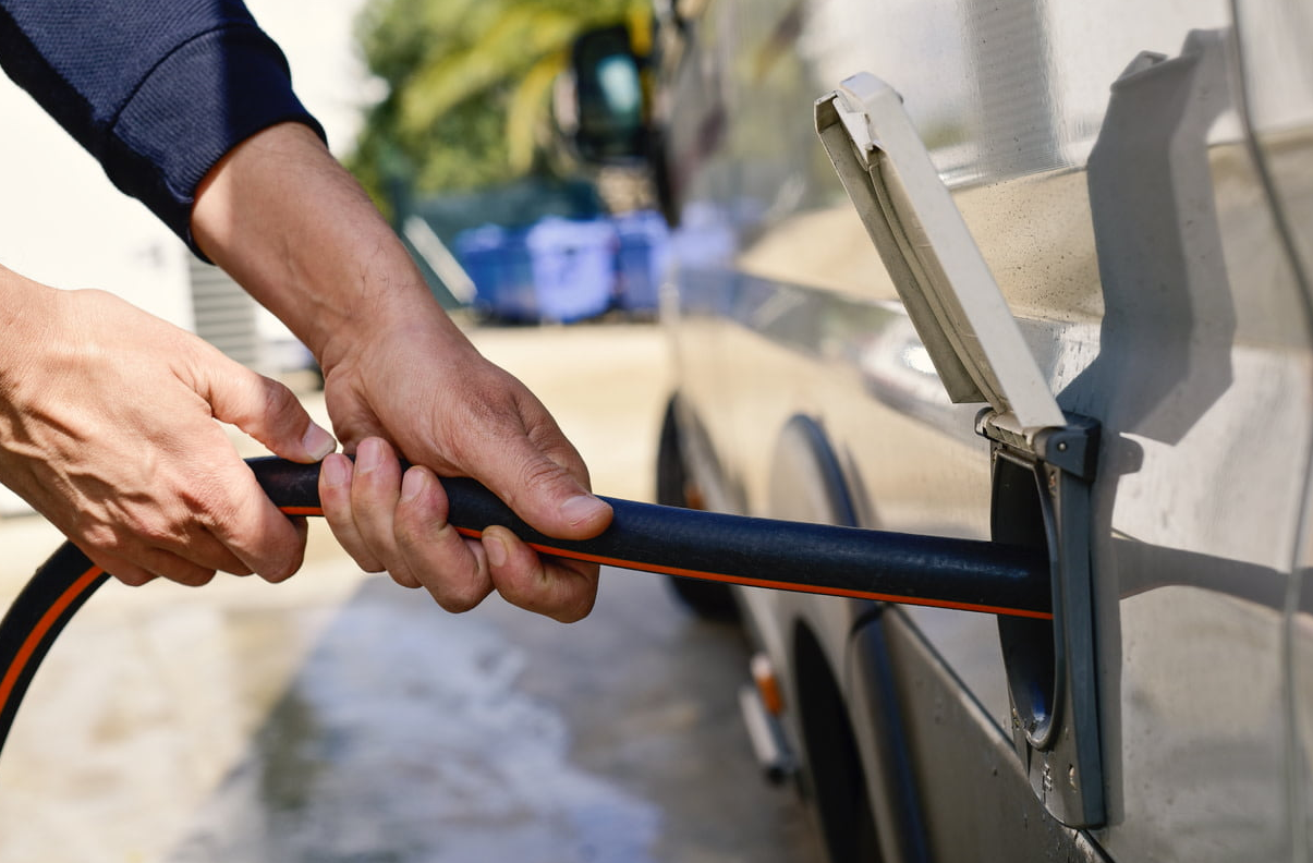 RV technician diagnosing toilet issue inside an RV in Port St. Lucie